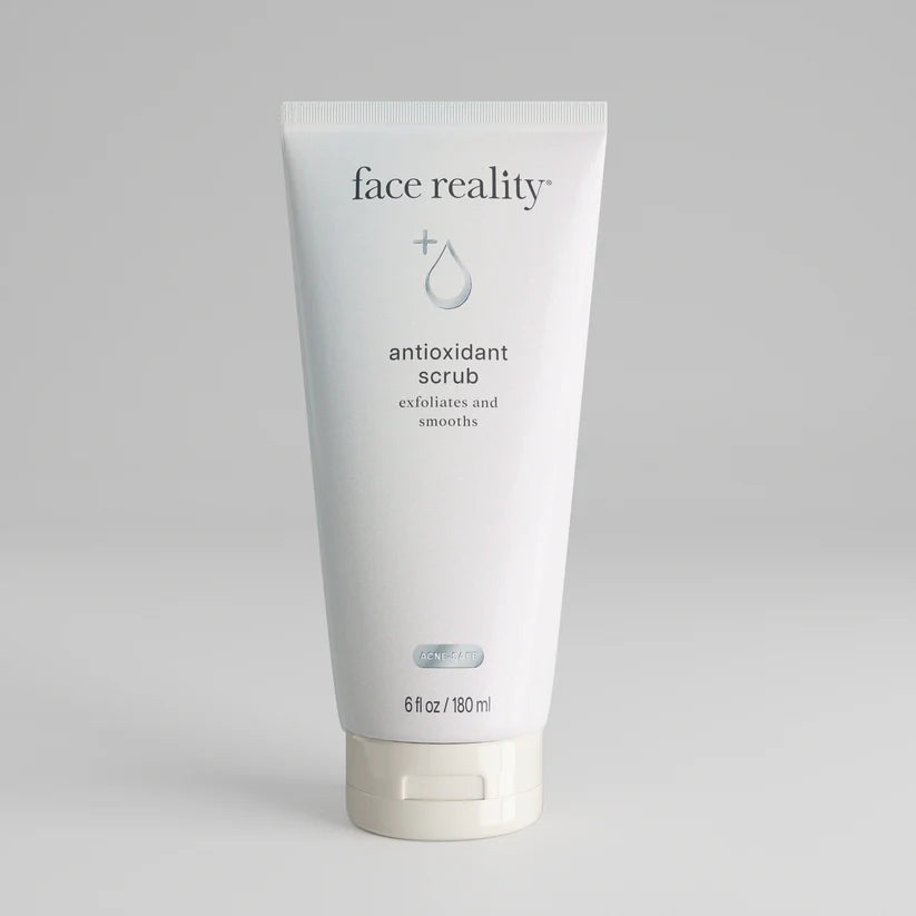 Tube of 'face reality' antioxidant scrub on a gray background