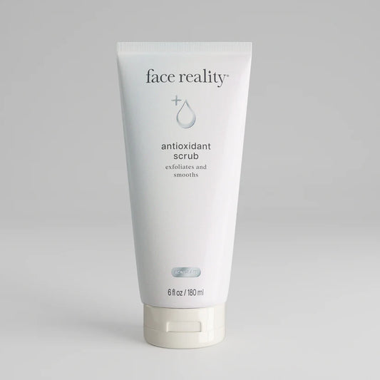 Tube of 'face reality' antioxidant scrub on a gray background