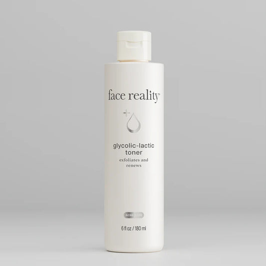 Bottle of 'face reality' glycolic-lactic toner on a gray background