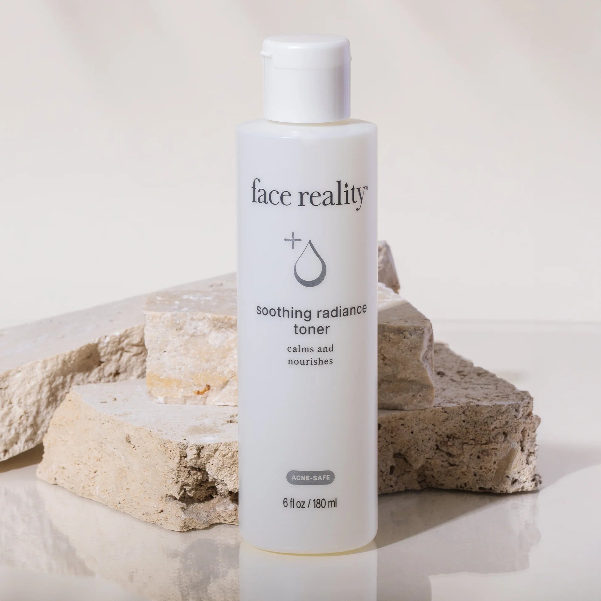 Bottle of 'face reality' soothing radiance toner on a neutral background