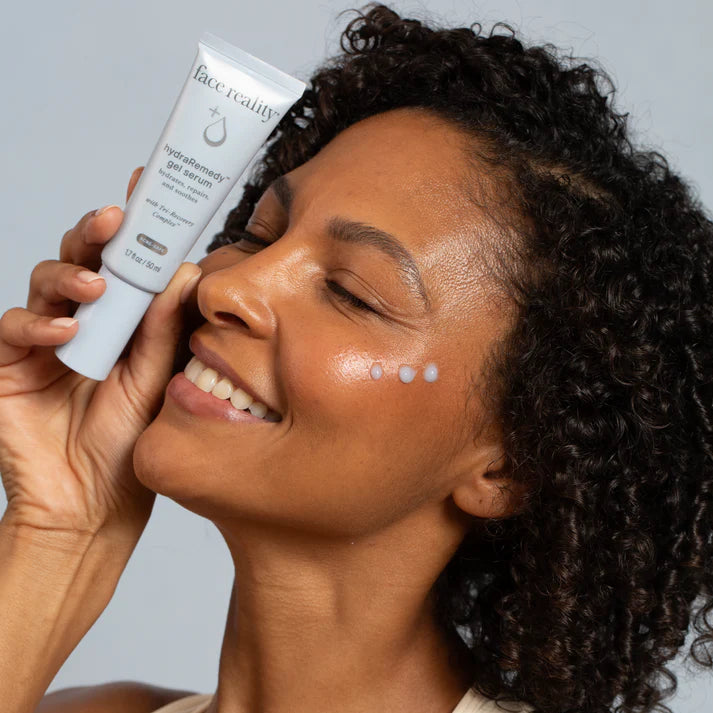 Woman applying Face Reality HydraRemedy gel serum