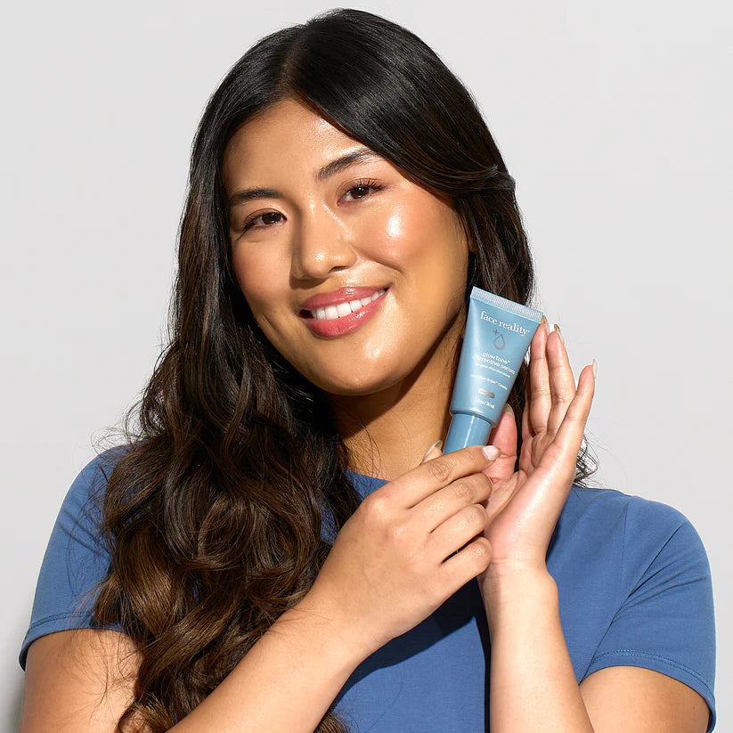Woman holding a blue skincare product