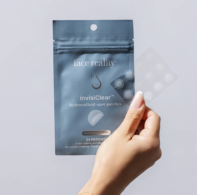 Hand holding a package of face reality invisiClear hydrocolloid spot patches