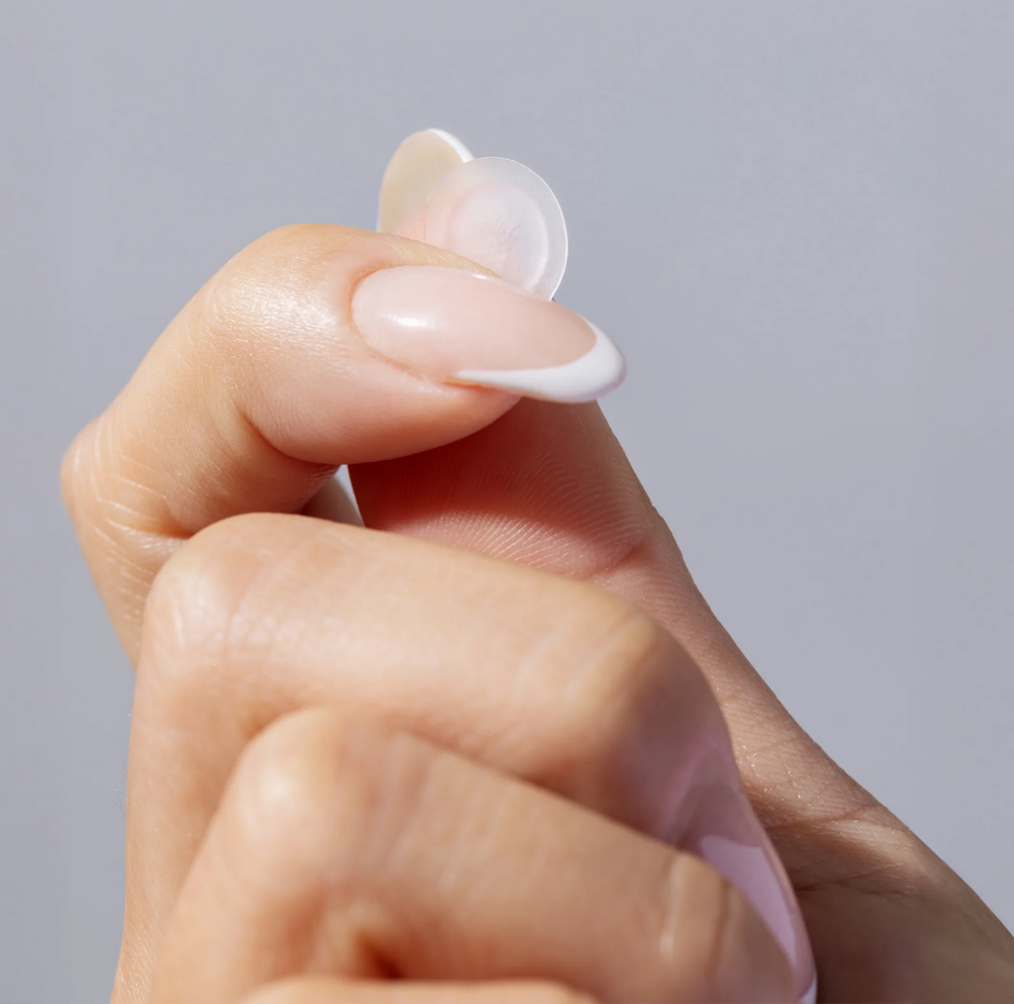 Hand holding an InvisiClear Pimple Patch