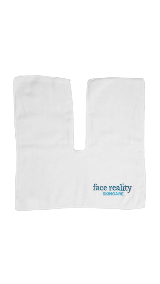 White treatment towel with the words 'face reality skincare'